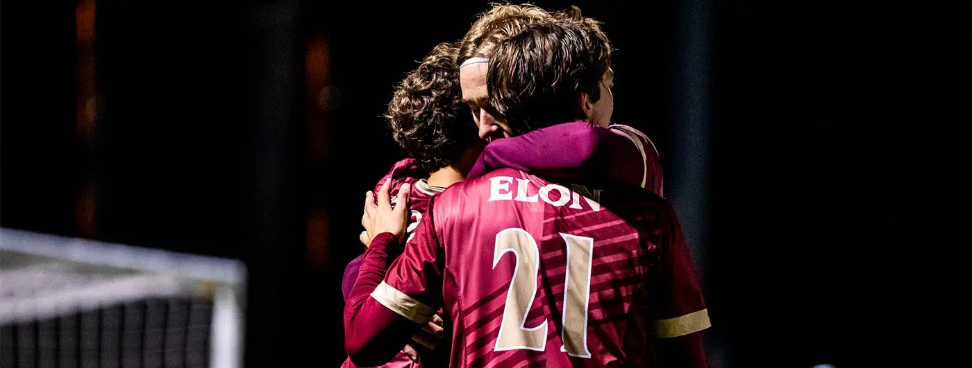 Three athletes hugging