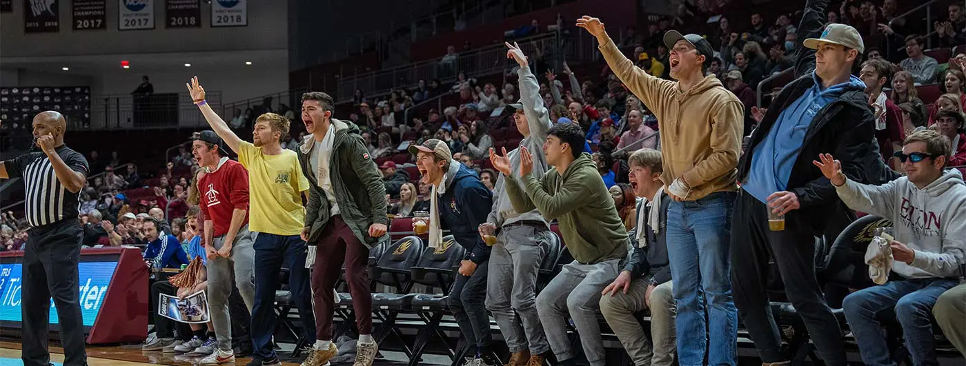 People cheering on the side of the court