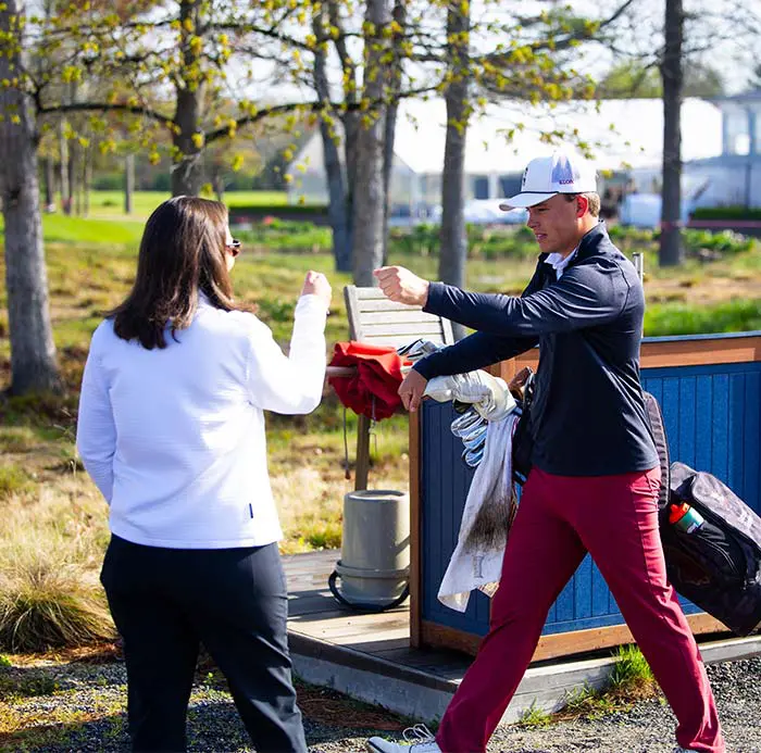 Two women fist bumping