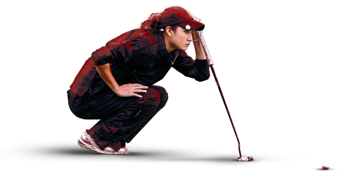 Golfer squatting down looking at ball